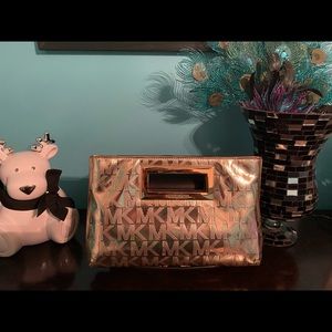 Michael Kors clutch shiny gold with MK signature insignia.